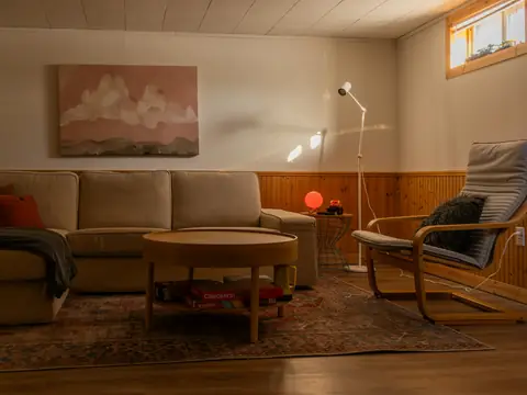 Ombonat vardagsrum med soffa och golvlampa